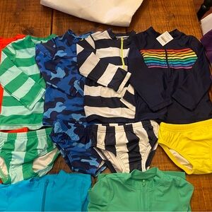 Lot of Primary swim- 7 rash guard and 5 swim diapers! So easy to mix and match